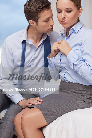 Passionate business couple in hotel room