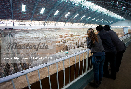 Tourists view infantry figures from the edge of Pit 1 at Qin Museum, exhibition halls of Terracotta Warriors, China