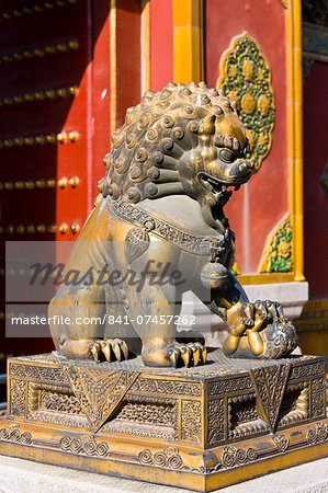 Gilded female lion statue with lion cub under paw in the Forbidden City, Beijing, China