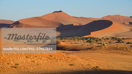 Looking towards the dunes of Sossusvlei, with two tiny figures on the lower ridge of the dune, Namib Naukluft, Namibia, Africa