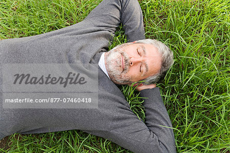 Mature man laying on the grass