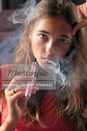 France, young girl smoking an electronic cigarette