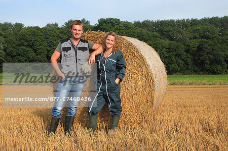 France, young farmer couple posing smiling.