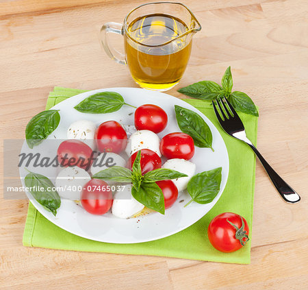 Caprese salad plate on wooden table