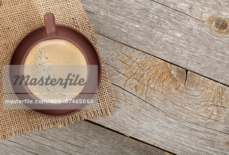 Coffee cup on wooden table background with copy space