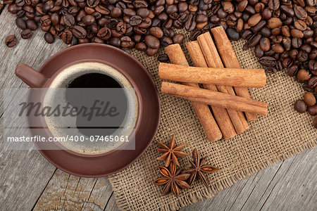 Coffee cup and spices on wooden table texture