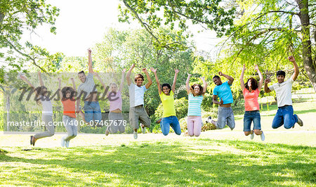 Group of cheerful multiethnic friends jumping in park
