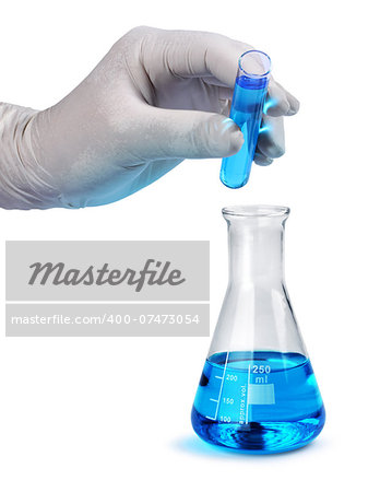 Gloved hand pours blue liquid laboratory test sample