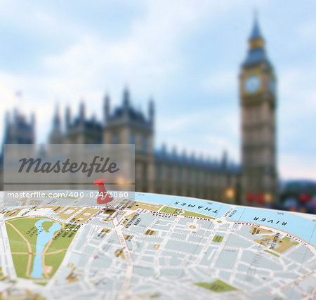 Red push pin pointing planned travel destination on London city map