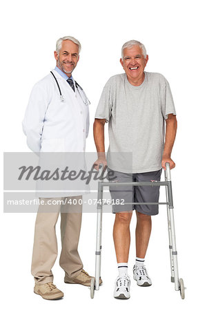 Full length portrait of a doctor with senior man using walker over white background