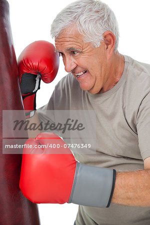 Portrait of a determined senior boxer over white background