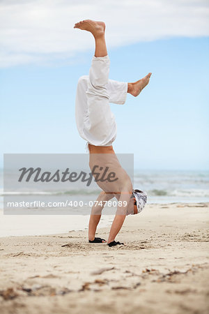 man is jumping sport karate martial arts fight kick jump beach summertime