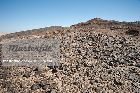 Rocky mountain slope landscape in an arid barren desert environment