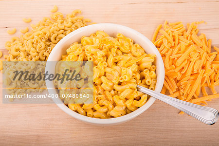 A bowl of macaroni and cheese with cayenne or paprika pepper