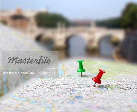 Push pins pointing planned travel destinations on tourist map, blurred background