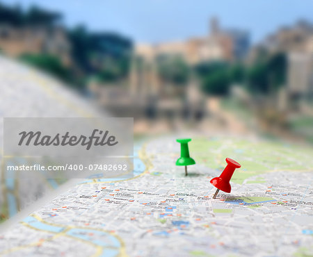 Push pins pointing planned travel destinations on tourist map, blurred background