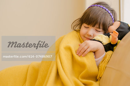 Young girl lying on sofa pretending to sleep Young girl lying on sofa pretending to sleep