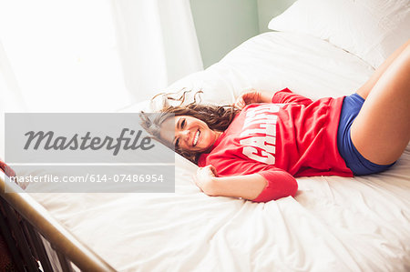 Young woman lying on bed