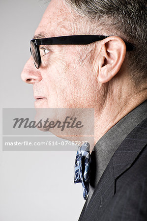 Portrait of senior man wearing bowtie, side view