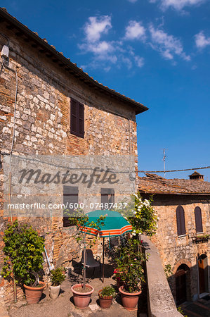 View of building with balcony garden, San Gimignano, Province of Siena, Tuscany, Italy