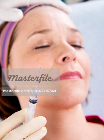 Doctor with Syringe about to Inject Patient