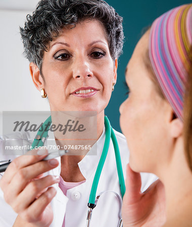 Doctor Marking Woman's Face for Treatment Doctor Marking Woman's Face for Treatment