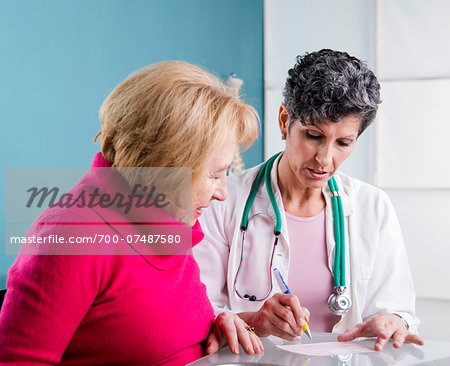 Doctor talking with Senior Patient in Doctor's Office