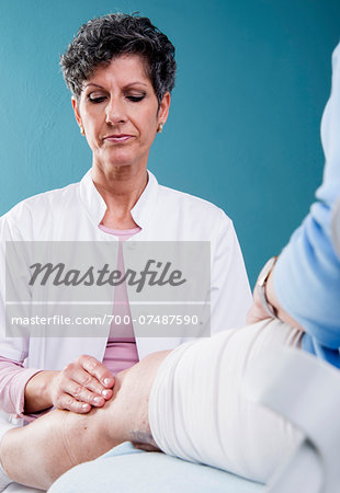 Doctor Examining Senior Patient in Doctor's Office