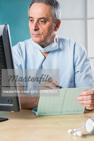 Doctor with Sugical Mask at Computer