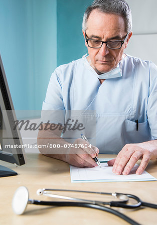 Doctor with Sugical Mask doing Paperwork