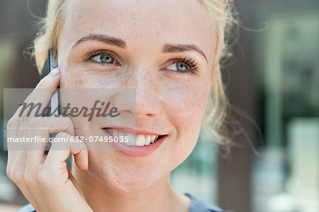 Young woman making phone call using smartphone