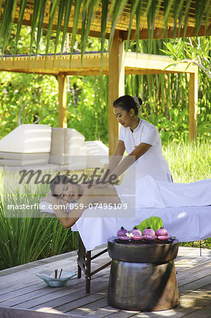 Woman Enjoying Massage in Exotic Resort