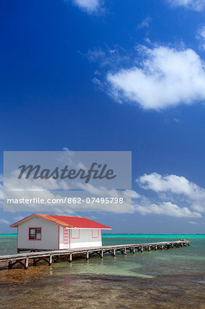 Central America, Belize, Ambergris Caye, San Pedro, a red hut on a jetty contrasted against the blue sky and turquoise Caribbean sea