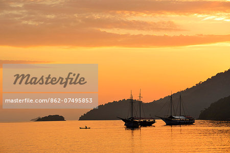 Person on canoe, cove at Ilha Grande, Rio de Janeiro, Brazil, South America