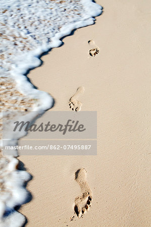 Caribbean, Dominican Republic, La Altagracia province, Punta Cana, Bavaro, footprints in the sand with a breaking wave