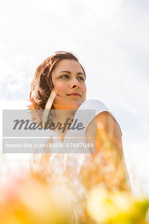 Peaceful woman reflecting in nature looking away and thinking