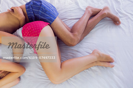 Young couple sleeping in their bed in the bedroom