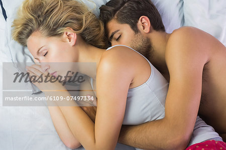 Peaceful young couple sleeping in their bed in the bedroom