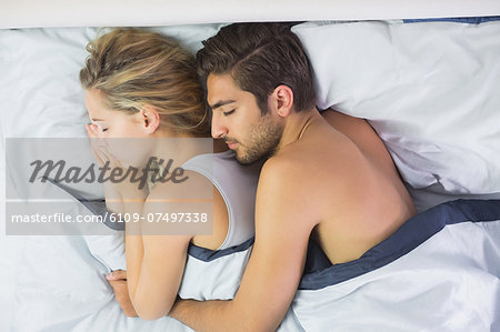 Attractive Calm Couple Sleeping In Their Bed In The Bedroom