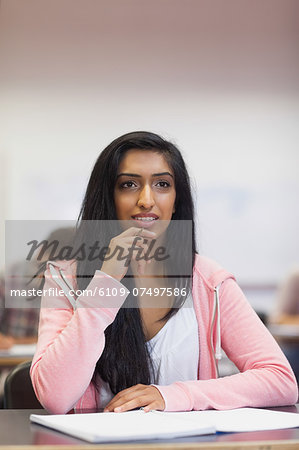 Smiling indian student listening in class at the university