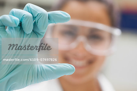 Close up of hand in rubber glove presenting something in lab at college