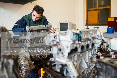 Repairman repairing an engine in workshop