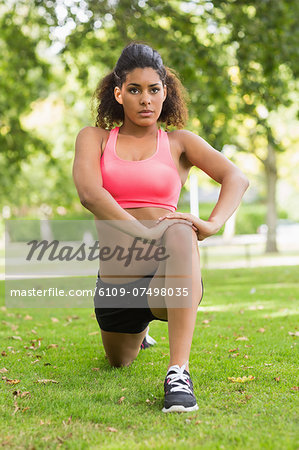 Full length of a toned and flexible woman doing stretching exercise in the park