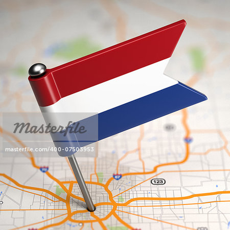 Small Flag of Netherlands Sticked in the Map Background with Selective Focus.