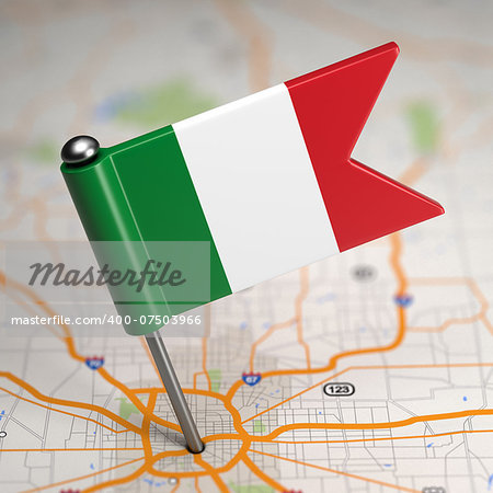 Small Flag of Italy Sticked in the Map Background with Selective Focus.