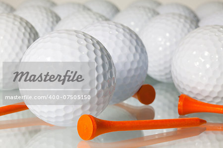 Different golf balls on a glass table