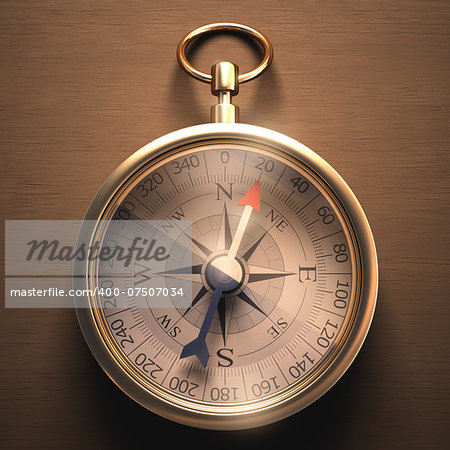 Compass on a wooden table with clipping path included.