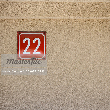 Number 22 on textured concrete wall