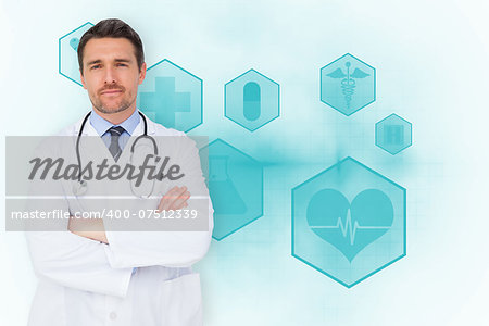 Handsome young doctor with arms crossed against blue medical interface with icons