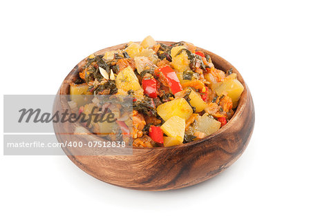 Vegetable Ragout in a wooden bowl. Isolated on white